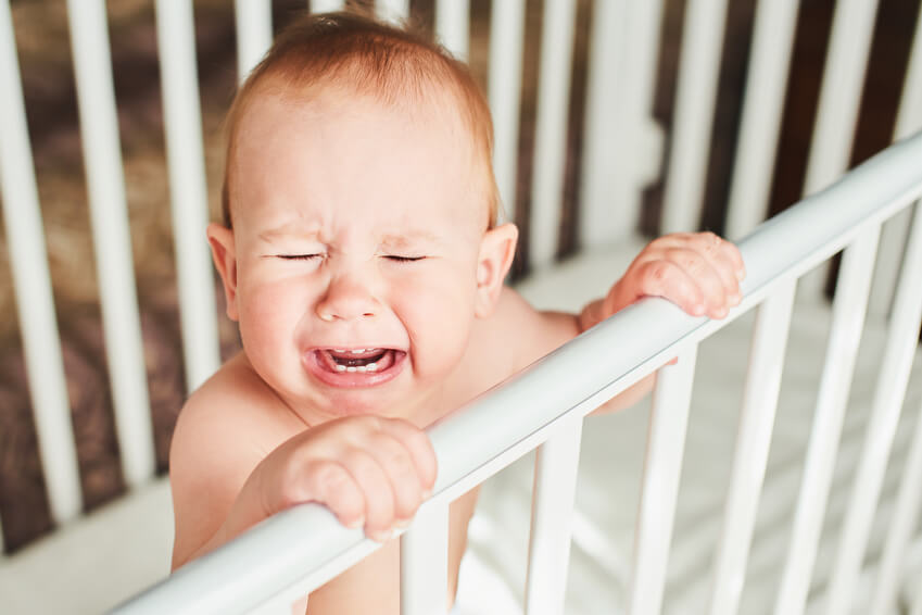 coping with extinction bursts while sleep training; baby crying in a crib