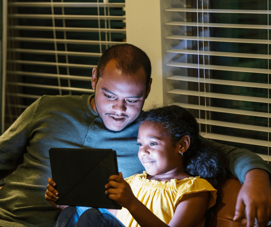 Three Things to Remove from Your Child's Room Tonight; father and daughter watching a video tablet